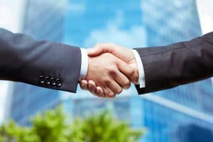 Close-up of business people handshaking on background of modern